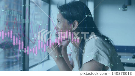 Leaning woman in light blouse gazing at glass pane, desk with market charts overlaid, copy space 140878018