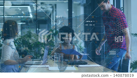 Collaborating team around table in office with projected map, holding blue folder, wearing plaid Collaborating team around table in office with projected map, holding blue folder, wearing plaid 140878019