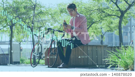 Holding smartphone, Asian man in pink blazer checking financial charts at sunny plaza with bicycle Holding smartphone, Asian man in pink blazer checking financial charts at sunny plaza with bicycle 140878020