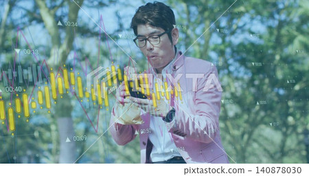 Studying man in pink blazer viewing financial data on phone with wrapped sandwich in park, overlays Studying man in pink blazer viewing financial data on phone with wrapped sandwich in park, overlays 140878030