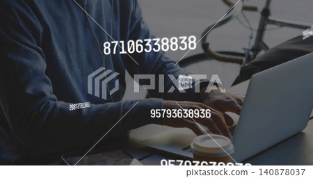 Typing man in dark blue sweater using silver laptop at home with coffee, bike, numeric overlays Typing man in dark blue sweater using silver laptop at home with coffee, bike, numeric overlays 140878037