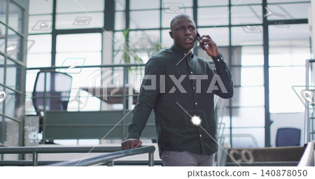 Talking man in dark shirt leaning on office mezzanine railing while holding phone, AR icons Talking man in dark shirt leaning on office mezzanine railing while holding phone, AR icons 140878050