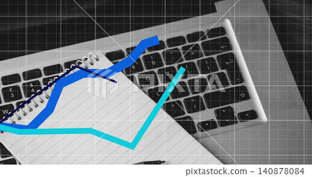 Resting spiral lined notebook blue coil across laptop keyboard, pen, grid, line graphs, copy space Resting spiral lined notebook blue coil across laptop keyboard, pen, grid, line graphs, copy space 140878084