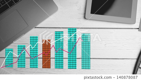 Displaying grid bar chart on desk, showing teal bars, orange bar, white and magenta lines, devices Displaying grid bar chart on desk, showing teal bars, orange bar, white and magenta lines, devices 140878087