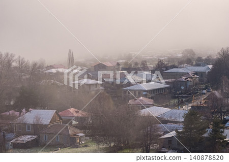Georgia. The picture shows residential buildings with tiled roofs, shrouded in thick fog Georgia. The picture shows residential buildings with tiled roofs, shrouded in thick fog 140878820