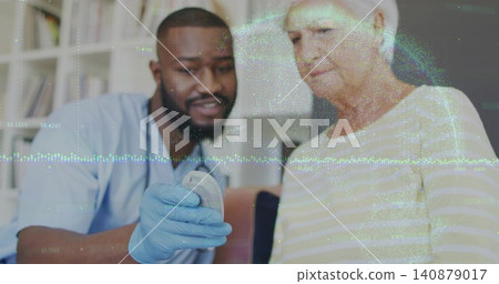 Demonstrating nurse showing hearing remote in living room, wearing scrubs, stethoscope, gloves 140879017