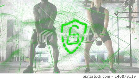 Swinging two athletes wearing tank and tee doing kettlebell swings in gym, green S overlay Swinging two athletes wearing tank and tee doing kettlebell swings in gym, green S overlay 140879119