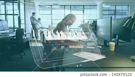 Leaning mid adult woman wearing blouse writing on charts in modern office, with data overlay Leaning mid adult woman wearing blouse writing on charts in modern office, with data overlay 140879120