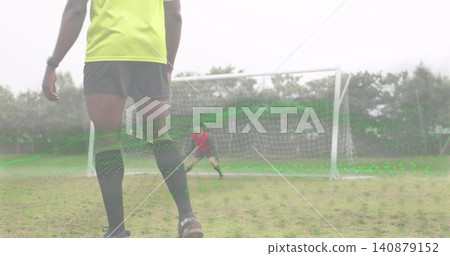 Standing neon-clad soccer player preparing to shoot on grassy pitch, with goal and green overlay Standing neon-clad soccer player preparing to shoot on grassy pitch, with goal and green overlay 140879152