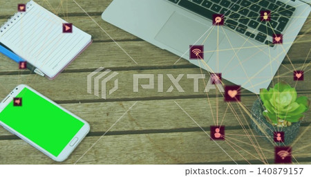 Showing green-screen phone lying lower-left on wood desk notebook laptop social-icons, copy space Showing green-screen phone lying lower-left on wood desk notebook laptop social-icons, copy space 140879157