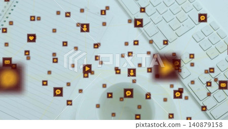 Floating network of orange social icons connecting over workspace, showing keyboard, notebook, cup Floating network of orange social icons connecting over workspace, showing keyboard, notebook, cup 140879158