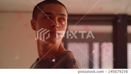 Turning male with shaved head gazing left in studio, septum ring, grey-ribbed sweater, red stars Turning male with shaved head gazing left in studio, septum ring, grey-ribbed sweater, red stars 140879256