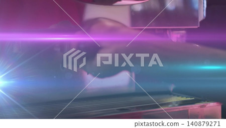 Leaning male worker operating horizontal metal press at workshop, with neon streaks and metal grate Leaning male worker operating horizontal metal press at workshop, with neon streaks and metal grate 140879271