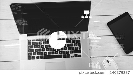 Showing laptop with keys, trackpad, running code on screen at wood desk, tablet, mouse, charts Showing laptop with keys, trackpad, running code on screen at wood desk, tablet, mouse, charts 140879287
