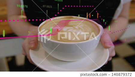 Holding white ceramic cup with latte art on saucer at cafe counter, showing financial chart overlay Holding white ceramic cup with latte art on saucer at cafe counter, showing financial chart overlay 140879372