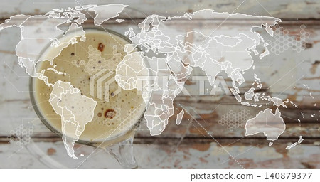 Sitting glass cup with saucer showing frothy crema on worn wooden table, map overlay, copy space 140879377