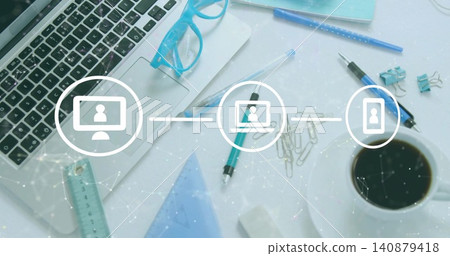 Showing central white desk with laptop, blue glasses on notepad, pens, ruler, coffee, network icons Showing central white desk with laptop, blue glasses on notepad, pens, ruler, coffee, network icons 140879418
