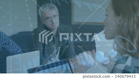 Leading woman checked top holding charts while team viewing laptop data at table, augmented data 140879433