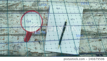 Resting spiral notepad with black ballpoint pen on worn wooden table, red mug and blue grid Resting spiral notepad with black ballpoint pen on worn wooden table, red mug and blue grid 140879506