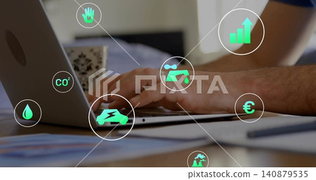 Typing man wearing dark shirt working at home desk, with laptop, patterned mug, papers, eco icons Typing man wearing dark shirt working at home desk, with laptop, patterned mug, papers, eco icons 140879535