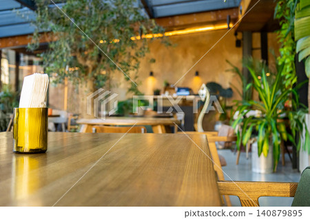 Wooden table with napkins in glass on foreground Wooden table with napkins in glass on foreground 140879895