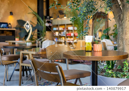 Wooden table in cafe with small plant and napkin holder Wooden table in cafe with small plant and napkin holder 140879917