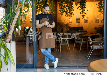 Full length portrait of waiter with tablet Full length portrait of waiter with tablet 140879970
