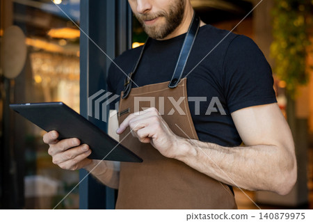 Barista hands holding tablet and tapping Barista hands holding tablet and tapping 140879975