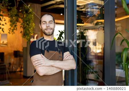 Proud small business owner smiling at camera in cafe Proud small business owner smiling at camera in cafe 140880021