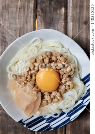 Handa somen noodles with natto and egg topping, served with homemade pickled young ginger. Handa somen noodles with natto and egg topping, served with homemade pickled young ginger. 140880129