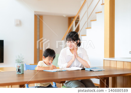 A female tutor teaches a first-grade boy. A female tutor teaches a first-grade boy. 140880589