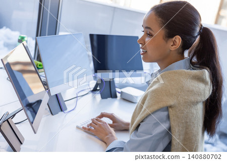 Young woman speaking during work in office Young woman speaking during work in office 140880702