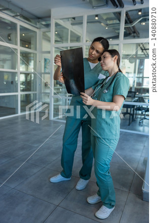Doctors in clinic analyzing xray results and discussing the diagnosis Doctors in clinic analyzing xray results and discussing the diagnosis 140880710