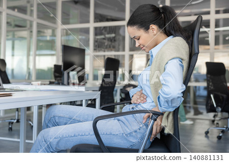 Woman suffering from stomach ache and back pain Woman suffering from stomach ache and back pain 140881131