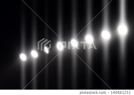 Bright lights create a mesmerizing pattern in a dark setting during an evening event Bright lights create a mesmerizing pattern in a dark setting during an evening event 140881251