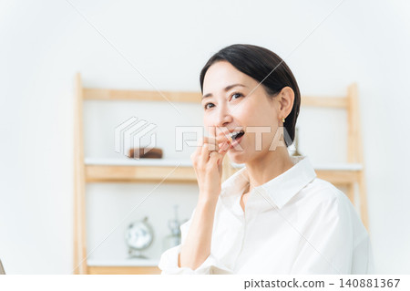 A woman taking medicine. Pharmaceuticals, supplements, over-the-counter medications, generics, vitamins, cold medicine, headache medicine, laxatives. A woman taking medicine. Pharmaceuticals, supplements, over-the-counter medications, generics, vitamins, cold medicine, headache medicine, laxatives. 140881367