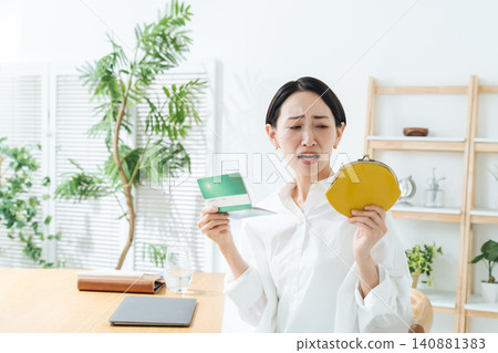A woman with a bankbook and wallet, troubled. Savings, money, investment, asset management, shopping, overspending, shopping, anxiety, worry A woman with a bankbook and wallet, troubled. Savings, money, investment, asset management, shopping, overspending, shopping, anxiety, worry 140881383