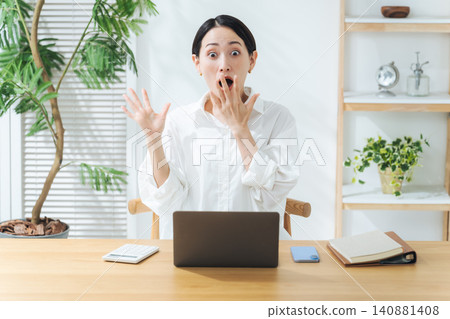 A middle-aged woman is surprised when she sees a laptop. (Keywords: surprise, shock, news, controversy, failure, work, video, social media) 140881408