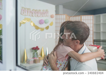 Loving daughter hugging father during birthday celebration at home Loving daughter hugging father during birthday celebration at home 140881484