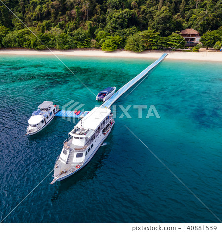 Aerial view of tour boats in front of the resort at Nyaung Oo Phee island in Myanmar 140881539