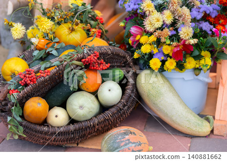 Colorful harvest display with fresh vegetables and vibrant flowers at a local market in autumn Colorful harvest display with fresh vegetables and vibrant flowers at a local market in autumn 140881662