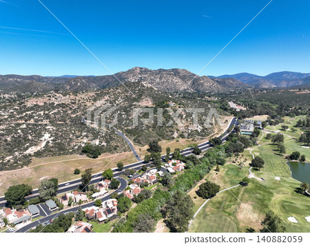 Aerial view of Ramona neighborhood with mountain, valley and golf course 140882059
