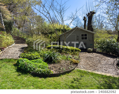 Enlgish green garden with multpiple type of trees and plants 140882092