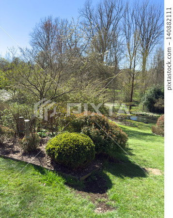 Enlgish green garden with multpiple type of trees and plants Enlgish green garden with multpiple type of trees and plants 140882111