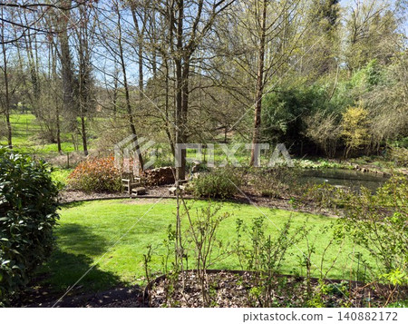 Enlgish green garden with multpiple type of trees and plants 140882172