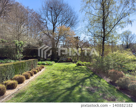 Enlgish green garden with multpiple type of trees and plants Enlgish green garden with multpiple type of trees and plants 140882182
