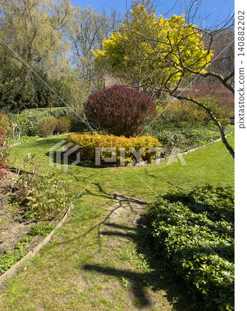 Enlgish green garden with multpiple type of trees and plants Enlgish green garden with multpiple type of trees and plants 140882202