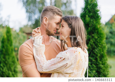 Romantic Couple Closeup Portrait In Garden With Tender Embrace Romantic Couple Closeup Portrait In Garden With Tender Embrace 140883311