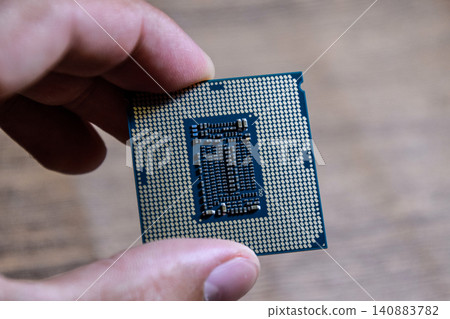 The processor is a desktop computer in hand. Inspect the CPU contacts before installing The processor is a desktop computer in hand. Inspect the CPU contacts before installing 140883782