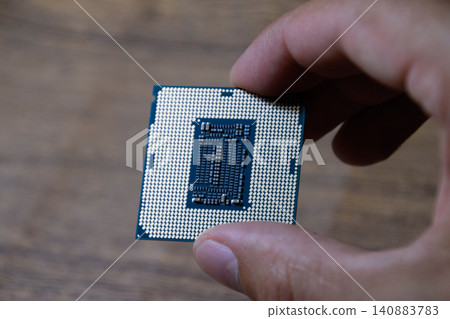 The processor is a desktop computer in hand. Inspect the CPU contacts before installing The processor is a desktop computer in hand. Inspect the CPU contacts before installing 140883783